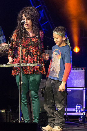 A local kid, Justin, performs with his music teacher, Emma Huntington and her band, The Locals, the Big Rock Show.