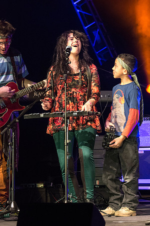 A local kid, Justin, performs with his music teacher, Emma Huntington and her band, The Locals, the Big Rock Show.