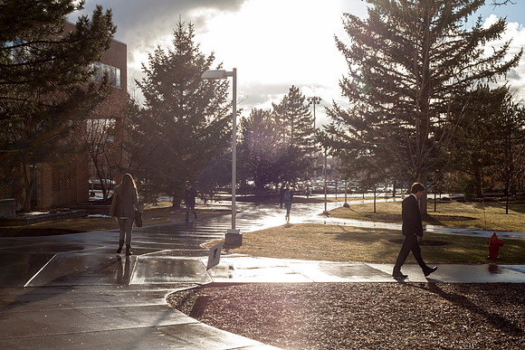 The students walk past the Romney Building after a light rain towards the final weeks of the 2015 Winter Semester.