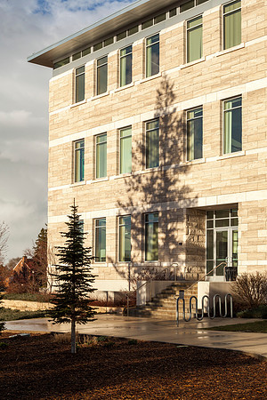 The sun set casts a strong shadow on the Spori Building after a rainstorm.