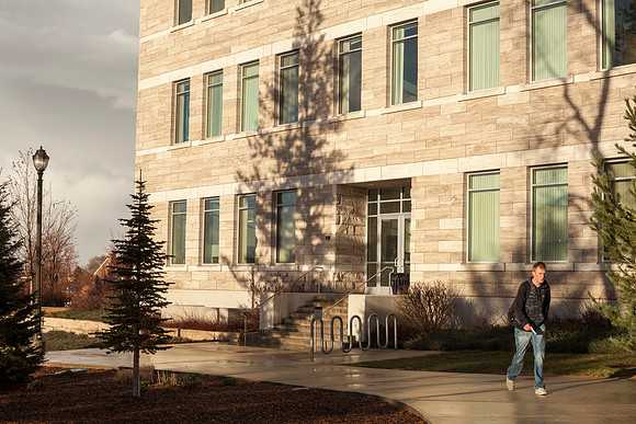 The sun set casts a strong shadow on the Spori Building after a rainstorm.