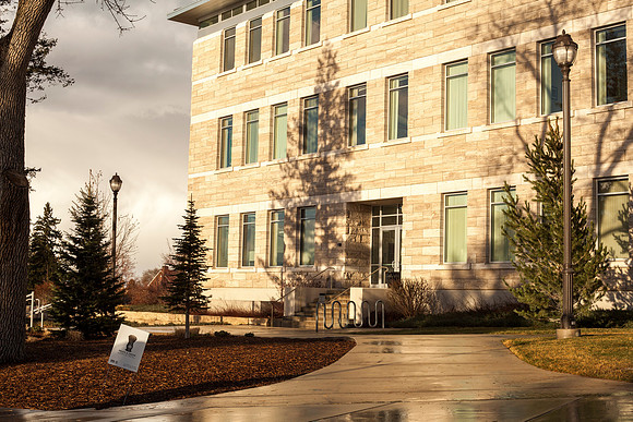 The sun set casts a strong shadow on the Spori Building after a rainstorm.