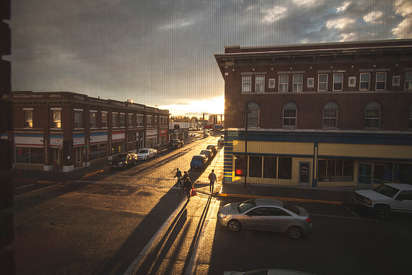 Looking out my bedroom apartment window, students walk across the street to Zeek's Famous Pie Shakes as the sun goes down behind the thick clouds.