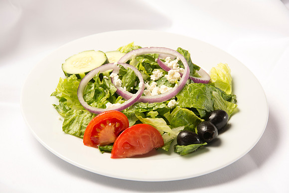 Crisp mixed greens garnished with tomato wedges, cool cucumbers, red onions, feta cheese, and kalamata olives. Topped with a Greek salad dress- ing.