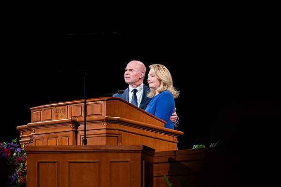 President and Sister Meredith speaking in devotional.