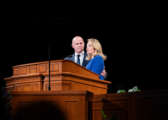 President and Sister Meredith speaking in devotional.