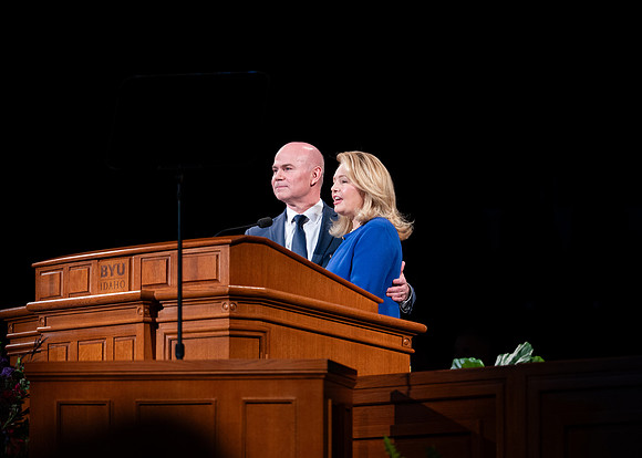 President and Sister Meredith speaking in devotional.