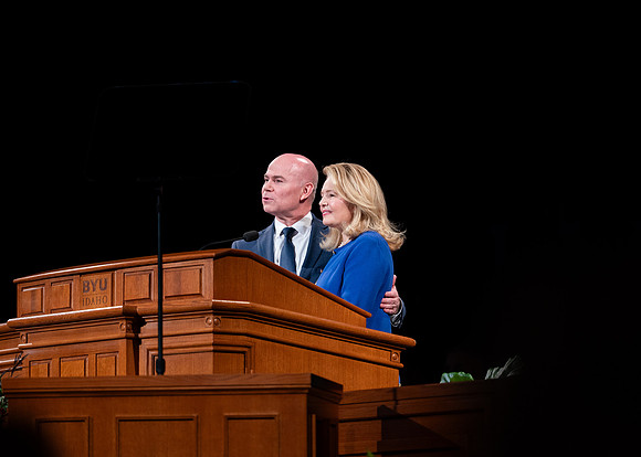 President and Sister Meredith speaking in devotional.