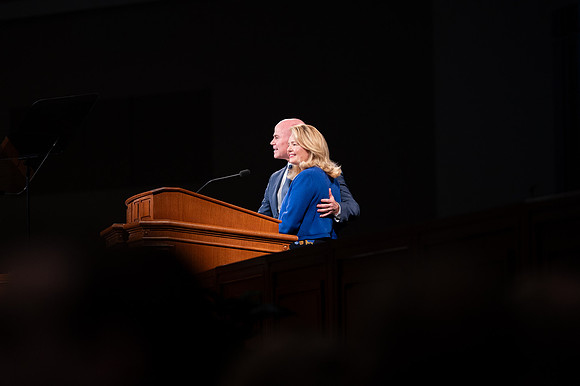 President and Sister Meredith speaking in devotional.