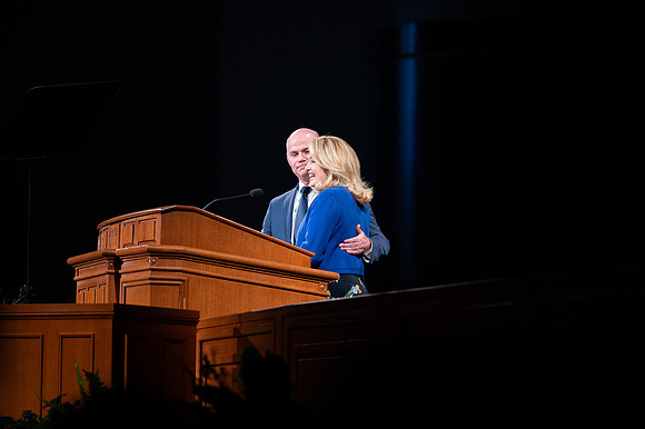 President and Sister Meredith speaking in devotional.