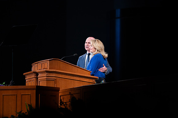 President and Sister Meredith speaking in devotional.