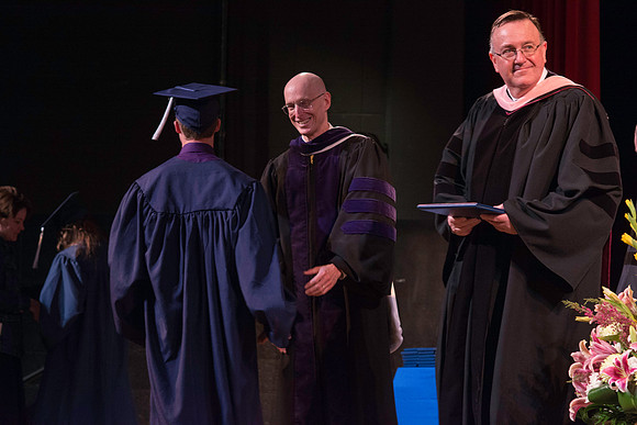 Jon Linford and Henry J. Eyring congratulate the graduates at the convocation for Interdisciplinary Studies.