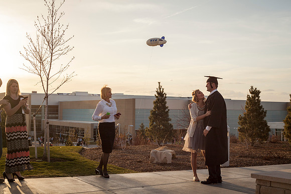 A graduate from BYU-Idaho gathers outside with his family after the commencement ceremony in the I-Center. Photo by Tyler D. Rickenbach.