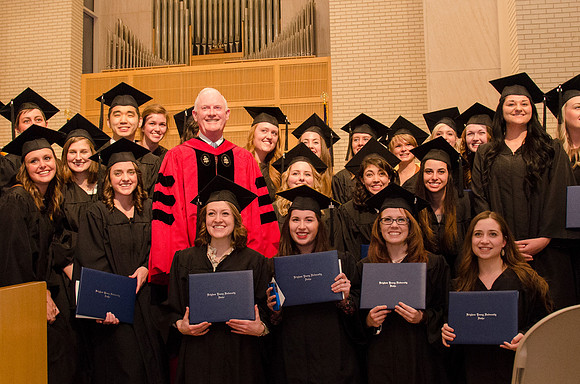 President Kim B. Clark poses with faculty and students during the College of Physical Science and Engineering Convocation. Photo by Erik Hill.