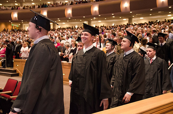 Graduates head to their seats during the Processional. Photo by Erik HIll.