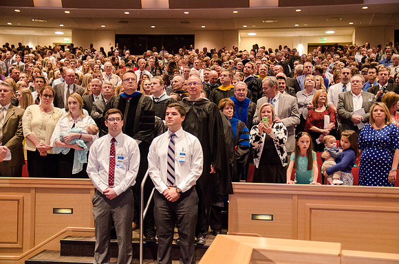 Teachers wait their turn to take their seats. Photo by Erik Hill.