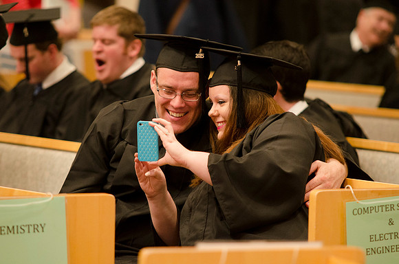 Graduates celebrate their graduation by taking a selfie! Photo by Erik Hill.