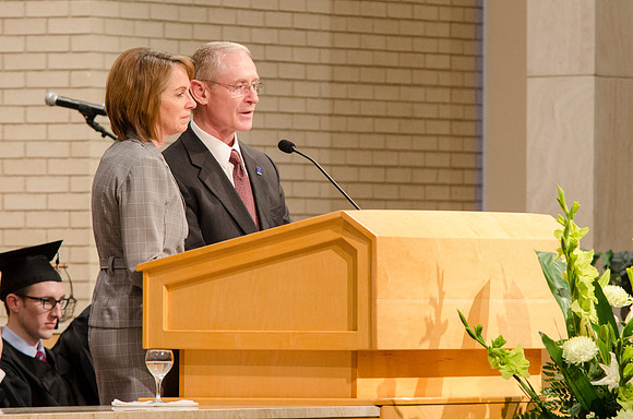 Alumni Representatives Dale and Jan Barnes welcome the Graduates to the Alumni Association. Photo by Erik Hill.