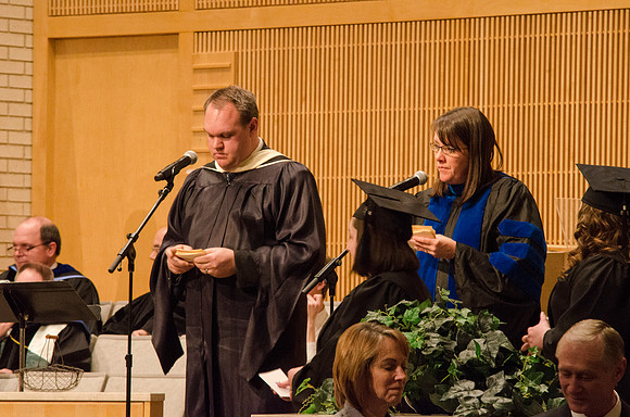 Heide Turner and Josh Tollefson read the Graduates names as they cross the stage. Photo by Erik Hill.
