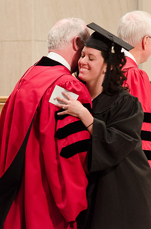 A student embraces President Kim B. Clark during the Convocation Ceremony. Photo by Erik Hill.