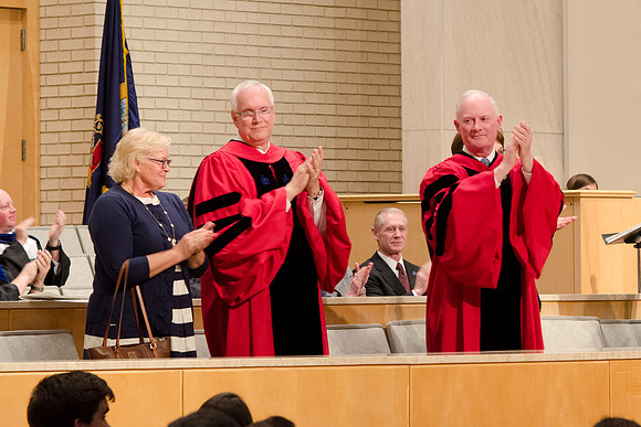 Elder Gay, his wife and President Kim B. Clark applaud the Graduates. Photo by Erik Hill.