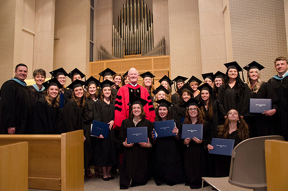 President Kim B. Clark poses with faculty and students during The College of Physical Science and Engineering Convocation. Photo by Erik Hill