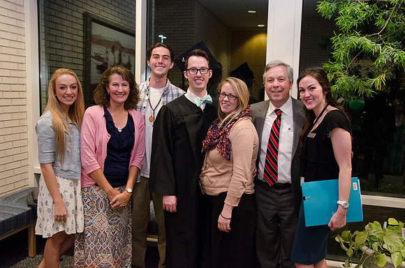 A proud family poses with their Graduate after the Convocation Ceremony. Photo by Erik Hill.