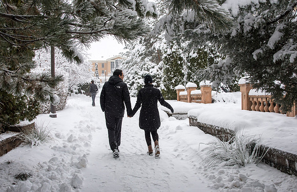 BYU-Idaho campus becomes a Winter Wonderland on graduation day. Carlos and Elizabeth Palomares stroll through the gardens.
