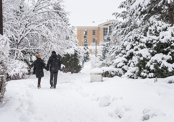 BYU-Idaho campus becomes a Winter Wonderland on graduation day. Carlos and Elizabeth Palomares stroll through the gardens.