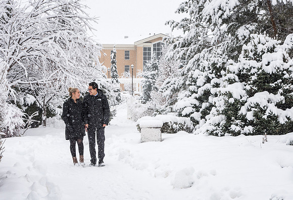 BYU-Idaho campus becomes a Winter Wonderland on graduation day. Carlos and Elizabeth Palomares stroll through the gardens.