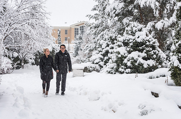 BYU-Idaho campus becomes a Winter Wonderland on graduation day. Carlos and Elizabeth Palomares stroll through the gardens.