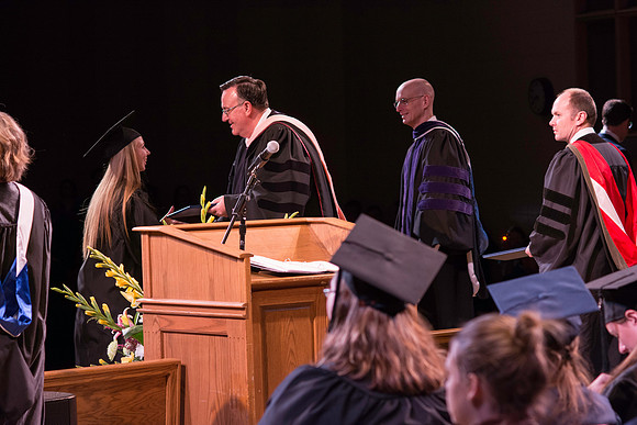 Jon Linford and Henry J. Eyring congratulate the graduates at the convocation for Interdisciplinary Studies.