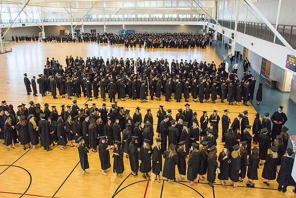 Graduates line up in the BYU-Idaho Center courts before the processional begins for Graduation at BYU-Idaho.