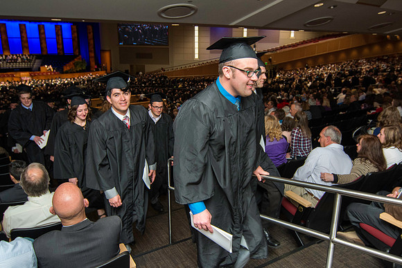 Graduates exit the auditorium at the end of commencment. Graduation at BYU-Idaho.