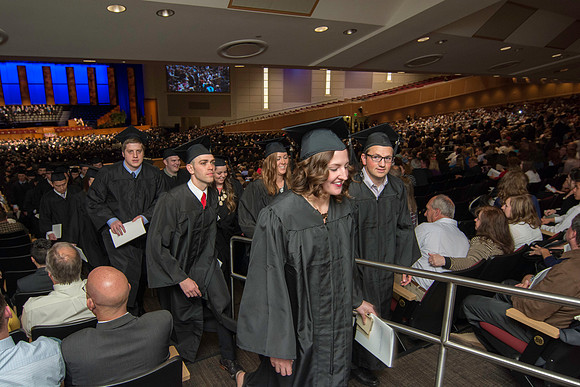 Graduates exit the auditorium at the end of commencment. Graduation at BYU-Idaho.