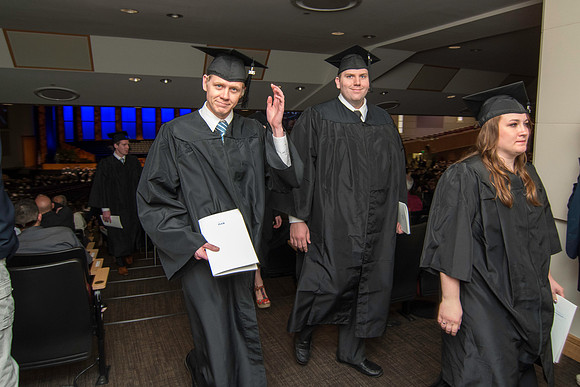Graduates exit the auditorium at the end of commencment. Graduation at BYU-Idaho.