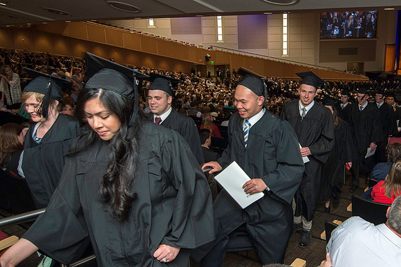 Graduates exit the auditorium at the end of commencment. Graduation at BYU-Idaho.