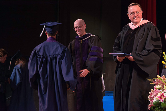 Jon Linford and Henry J Eyring congratulate the graduates at the convocation for Interdisciplinary Studies. Graduation at BYU-Idaho.