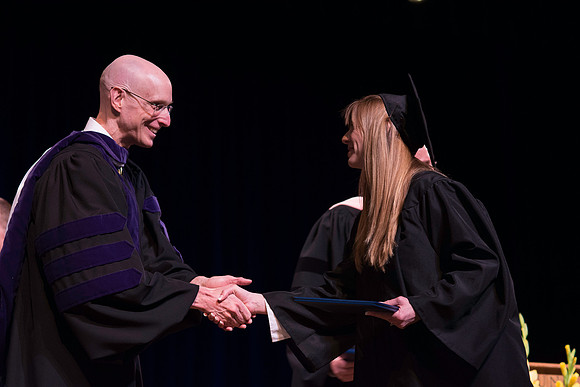Jon Linford and Henry J Eyring congratulate the graduates at the convocation for Interdisciplinary Studies. Graduation at BYU-Idaho.