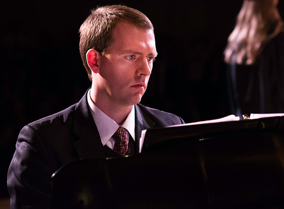 Graduation at BYU-Idaho. Alex Isakson at the piano during convocation for Interdisciplinary Studies.