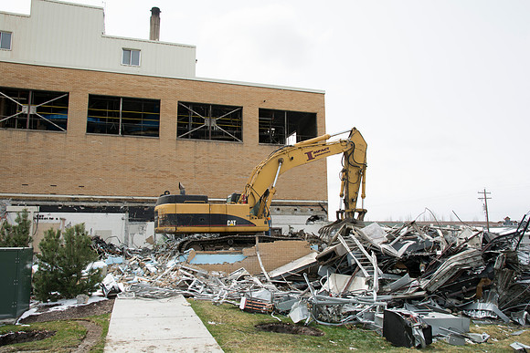 Workers demolish what remains of the old Heating Plant.