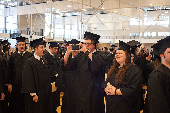 Communication graduates take a picture in the I-Center before the Commencement Ceremony.