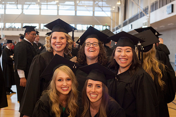 Communication graduates, Morgan Urness, Jessica Black, Nila Uriostegui, Candice Anderson and Whitney Claftin gather in the I-Center before the Commencement Cermony begins. Photo by Tyler D. Rickenbach