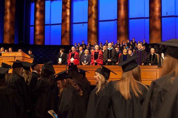 Speaker at April Commencement, Elder Robert C. Gay along with Elder Paul V. Johnson and President and Sister Clark, gather on the stand in the I-Center.