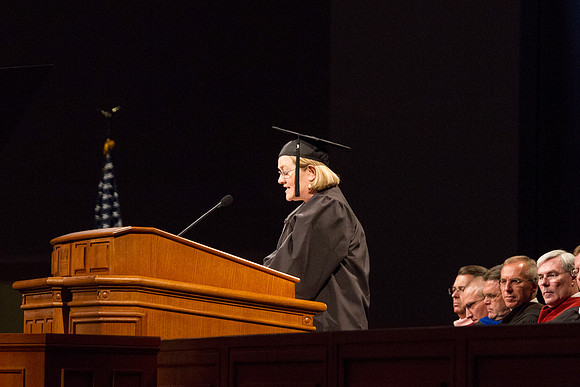 Susie Baird, an Elementary Educuation graduate, gives the scripture reading during the 2015 April Commencement Ceremony.