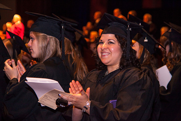 A graduate celebrates in the BYU-Idaho I-Center during the Commencement Ceremony.