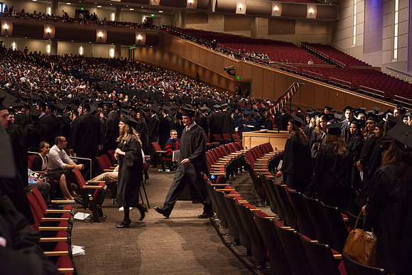 Graduates leave the BYU-Idaho Center in search for family members, after the Commencement Ceremony.