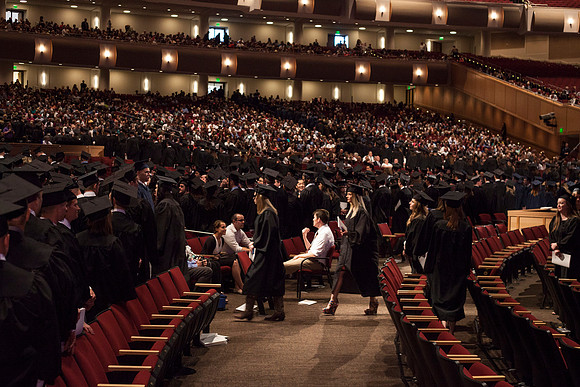 Graduates leave the BYU-Idaho Center in search for family members, after the Commencement Ceremony.