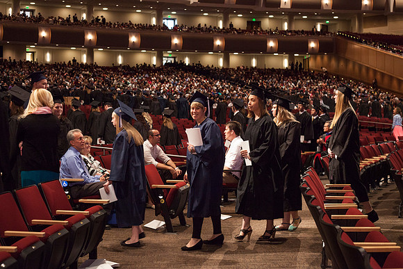 Graduates leave the BYU-Idaho Center in search for family members, after the Commencement Ceremony.