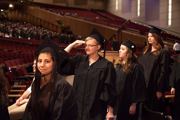 Graduates leave the BYU-Idaho Center in search for family members, after the Commencement Ceremony.